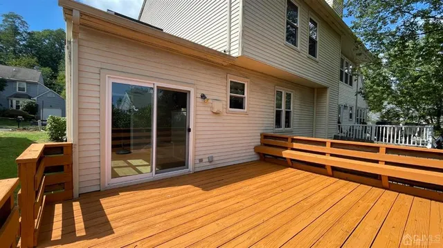 a view of a roof deck with wooden floor and fence
