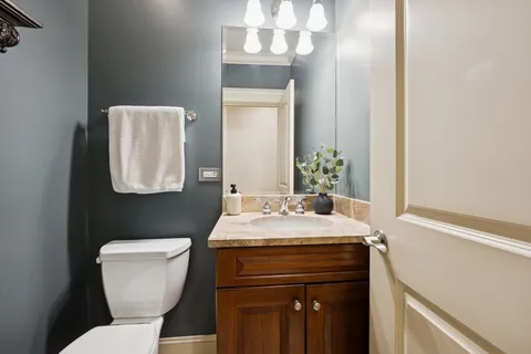 a living room with furniture a fireplace and a large mirror