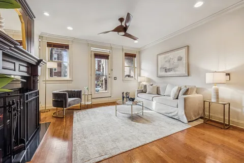 a view of a dining room with furniture wooden floor and chandelier