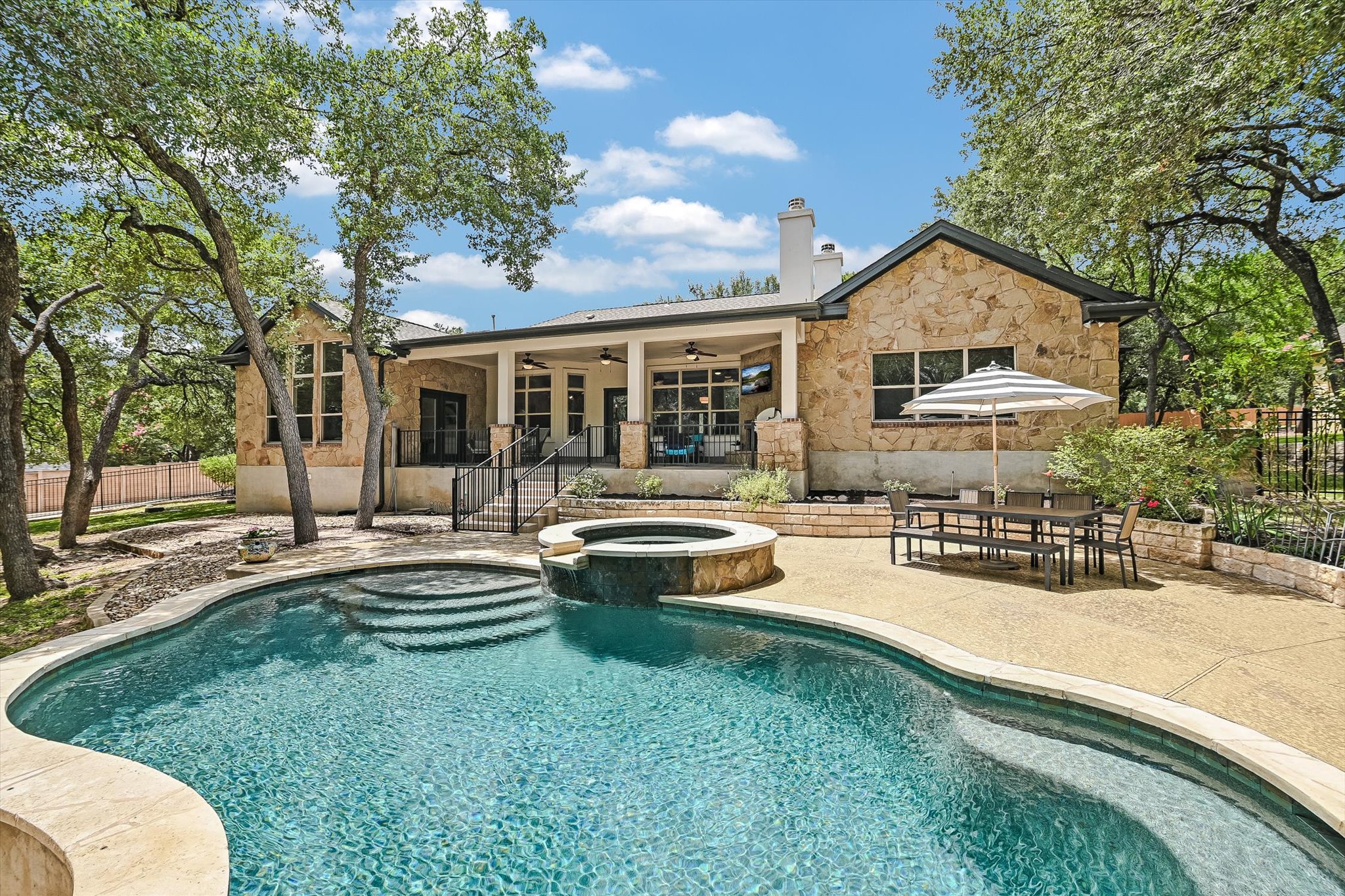 a view of a house with swimming pool and sitting area
