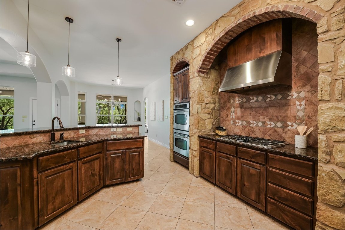 524 Highland Spring Lane Georgetown, TX 78633 - Photo 12 of 39 a kitchen with stainless steel appliances granite countertop a stove and a sink