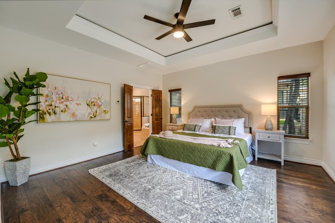 524 Highland Spring Lane Georgetown, TX 78633 - Photo 13 of 39 a bedroom with a large bed wooden floor and window