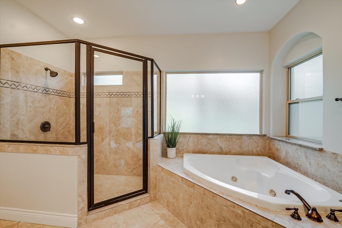 524 Highland Spring Lane Georgetown, TX 78633 - Photo 16 of 39 a bathroom with a bathtub and a shower