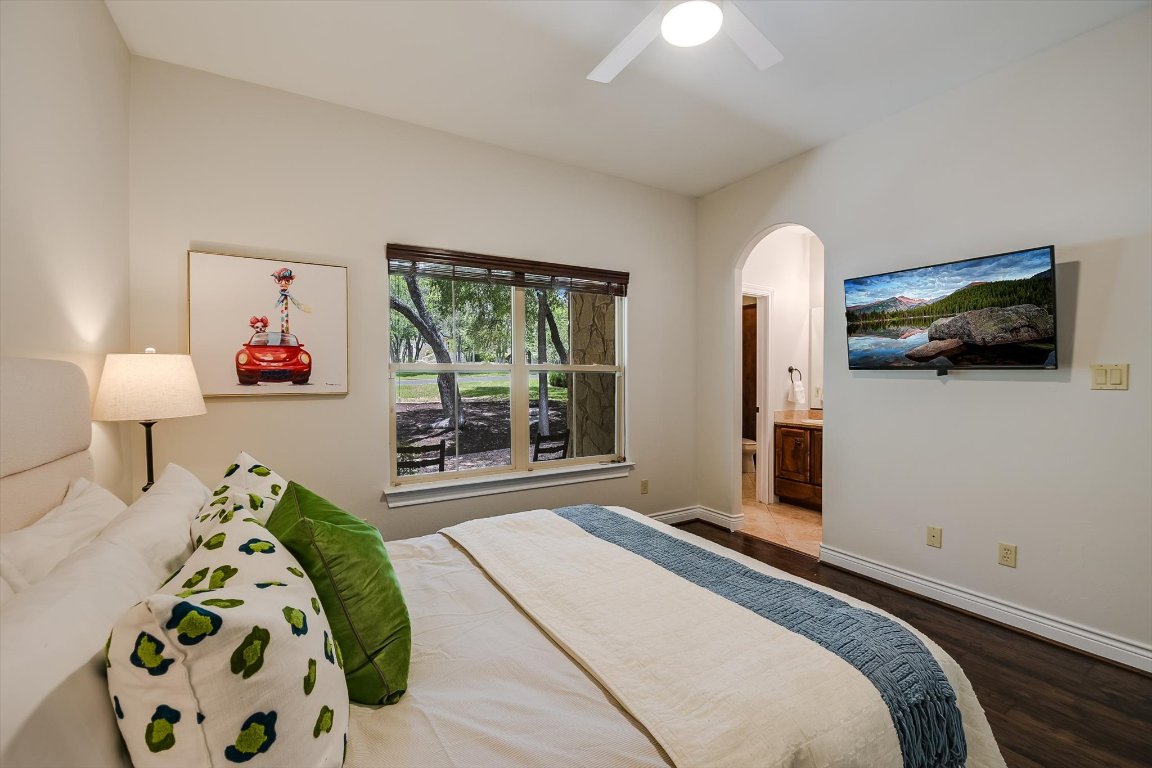 524 Highland Spring Lane Georgetown, TX 78633 - Photo 18 of 39 a bedroom with a bed and wooden floor