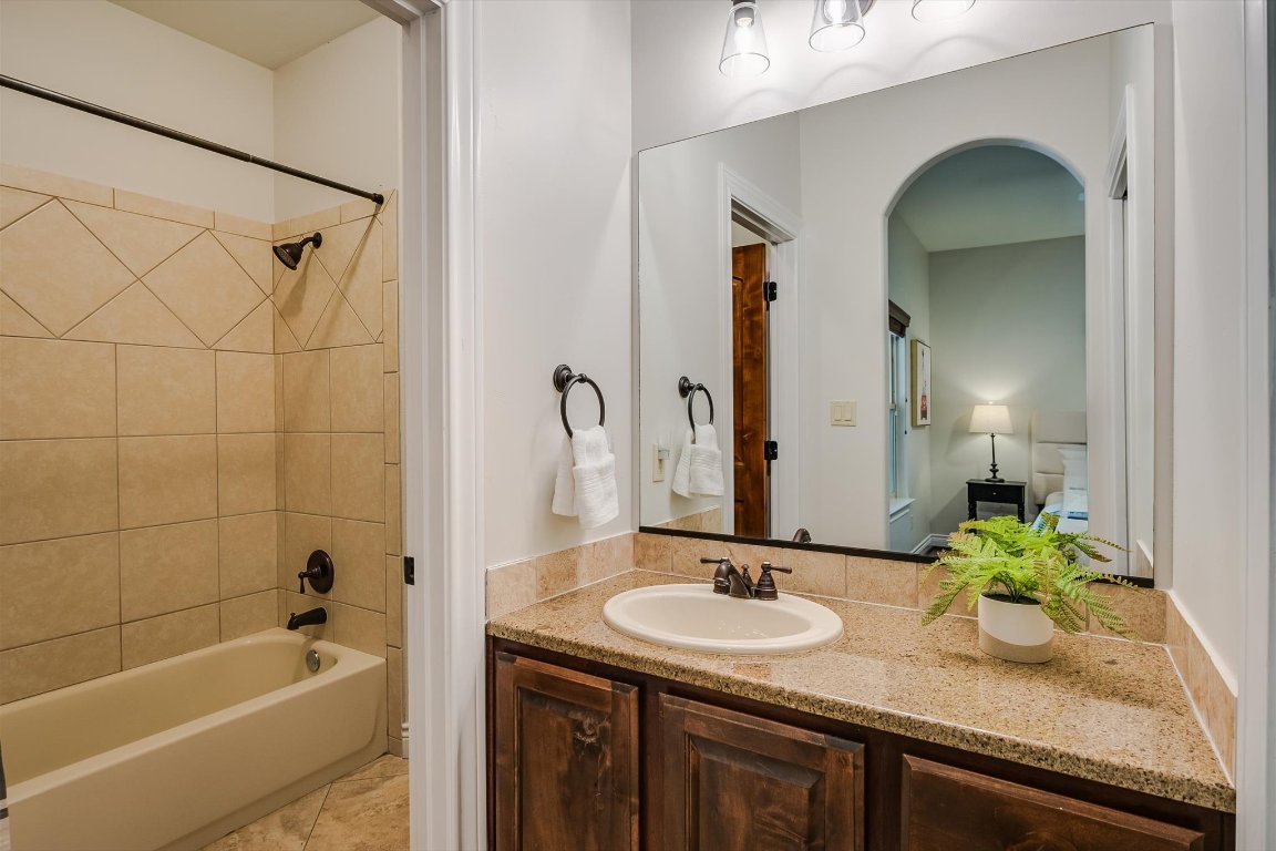 524 Highland Spring Lane Georgetown, TX 78633 - Photo 19 of 39 a bathroom with a granite countertop sink and a mirror