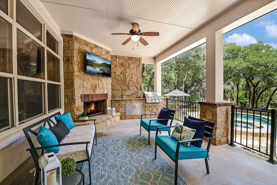 524 Highland Spring Lane Georgetown, TX 78633 - Photo 26 of 39 a living room with furniture a fireplace and a floor to ceiling window