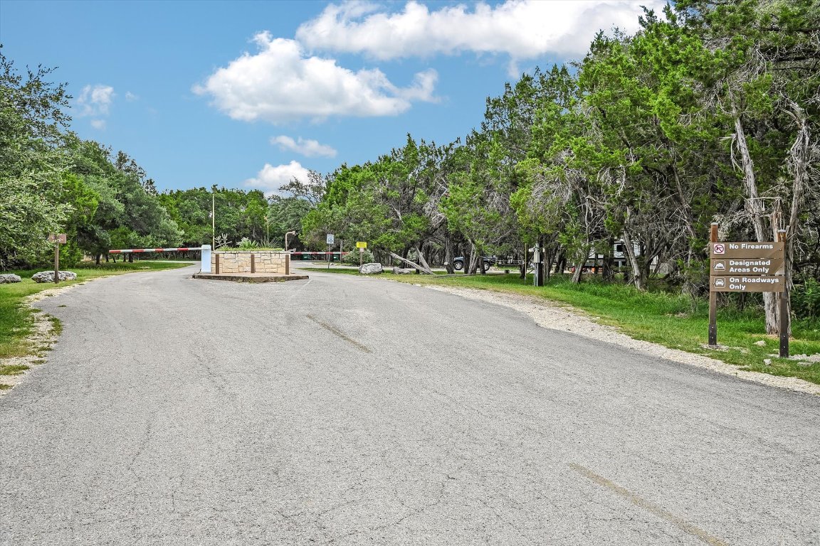 524 Highland Spring Lane Georgetown, TX 78633 - Photo 32 of 39 a view of a road with a big yard and large trees