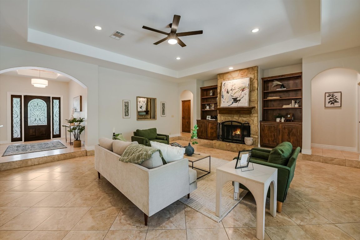 524 Highland Spring Lane Georgetown, TX 78633 - Photo 6 of 39 a living room with furniture a fireplace and a flat screen tv