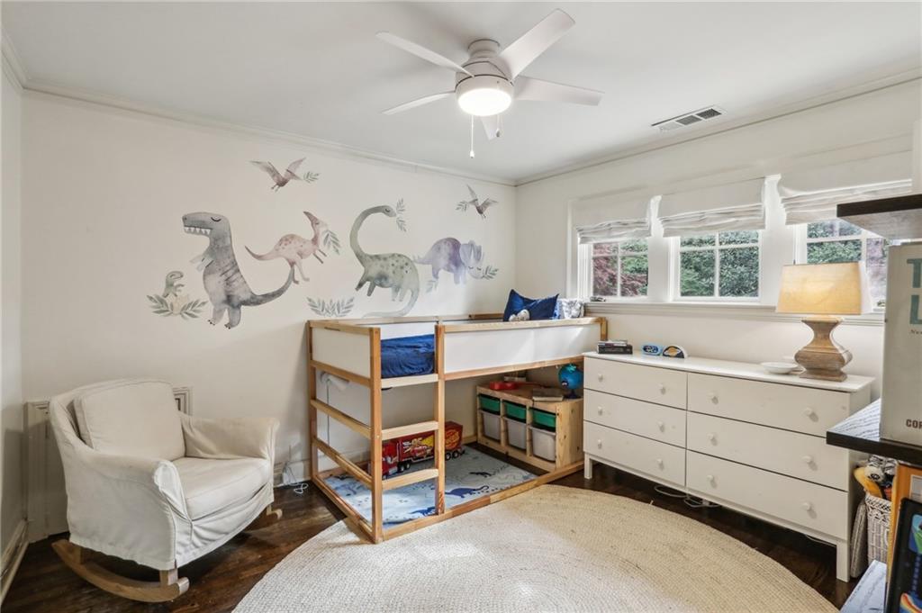 2415 Oldfield Road Northwest Atlanta, GA 30327 - Photo 17 of 27 a room with a baby crib furniture a chandelier and a dresser