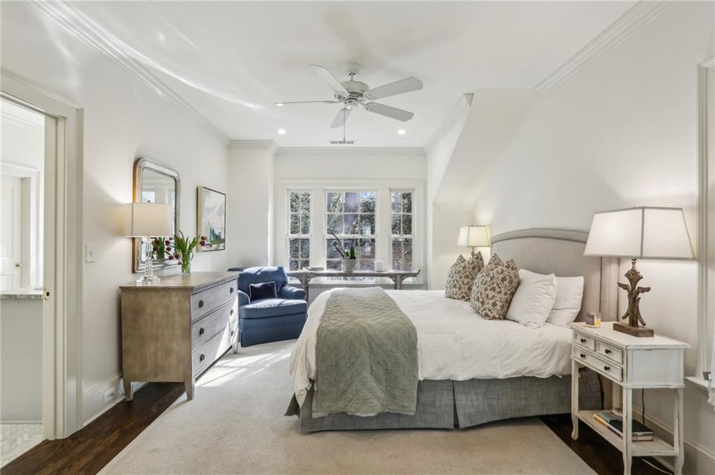 2415 Oldfield Road Northwest Atlanta, GA 30327 - Photo 23 of 27 a spacious bedroom with a bed and a chandelier