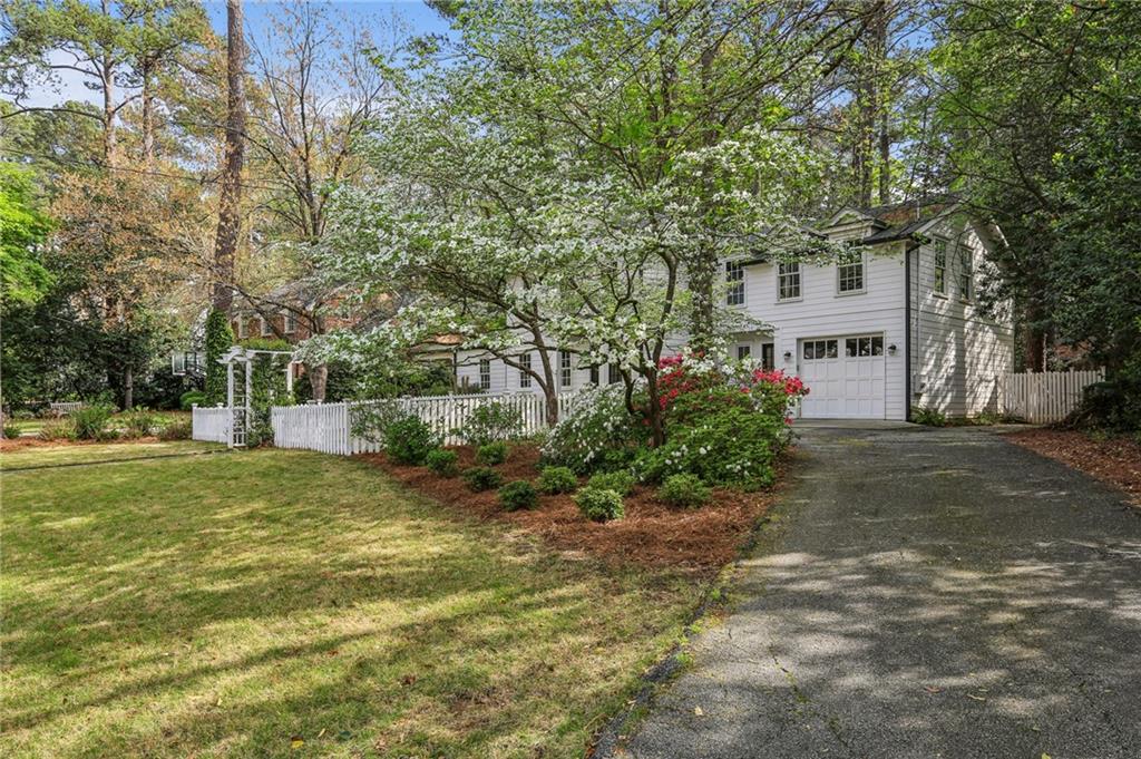 2415 Oldfield Road Northwest Atlanta, GA 30327 - Photo 3 of 27 a front view of a house with a yard