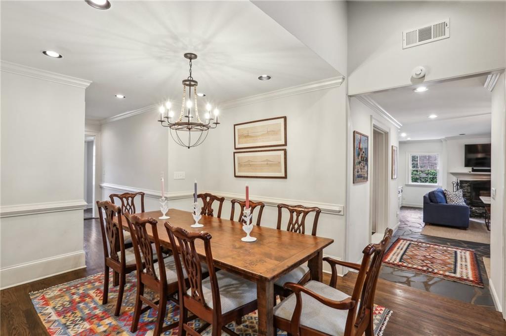 2415 Oldfield Road Northwest Atlanta, GA 30327 - Photo 5 of 27 a view of a dining room with furniture and wooden floor