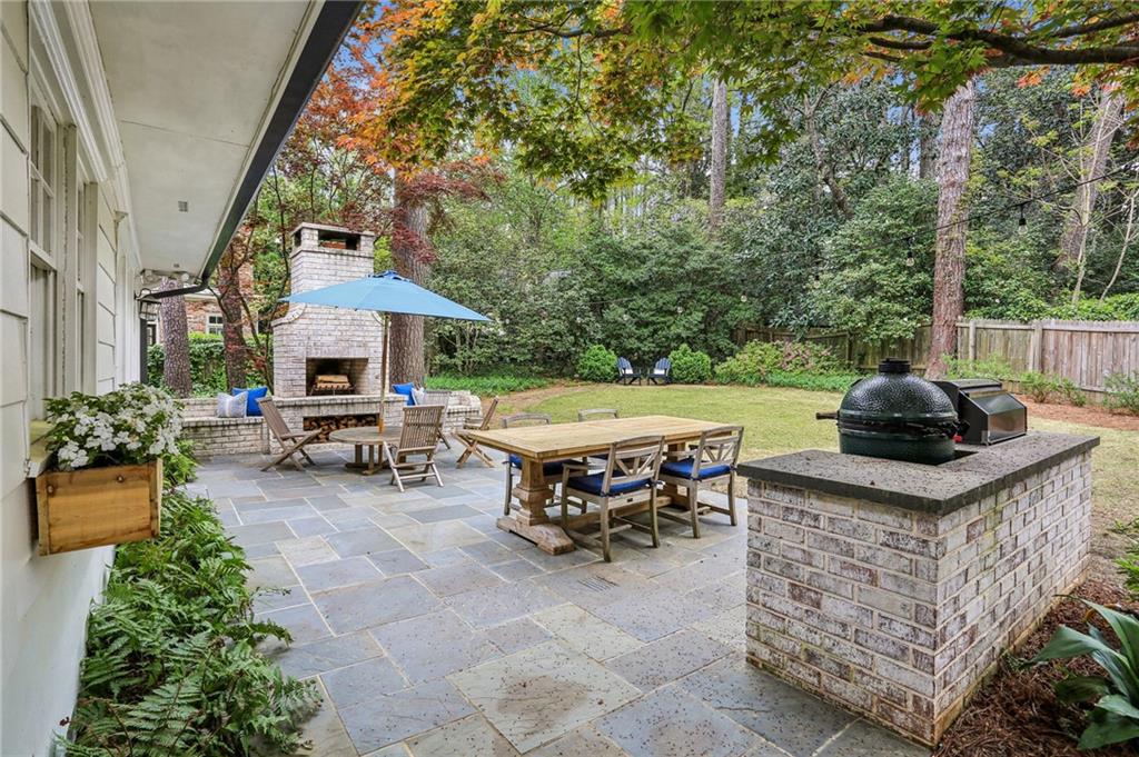 2415 Oldfield Road Northwest Atlanta, GA 30327 - Photo 7 of 27 a view of a patio with table and chairs potted plants with a tree