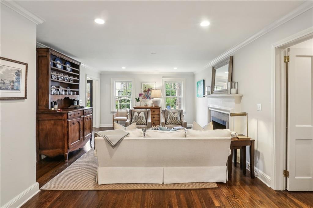 2415 Oldfield Road Northwest Atlanta, GA 30327 - Photo 9 of 27 a living room with fireplace furniture and a wooden floor