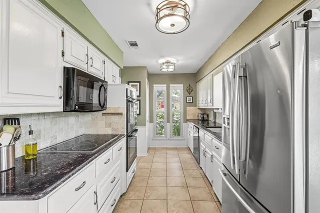 a dining room with furniture a chandelier and window