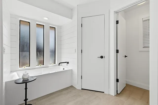 a bathroom with a double vanity sink mirror and shower