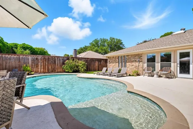 a patio with a table and chairs