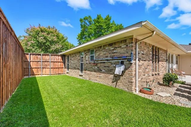 a view of a backyard with wooden fence