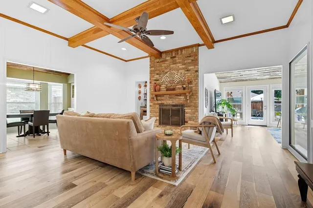 a view of a patio with a table and chairs under an umbrella