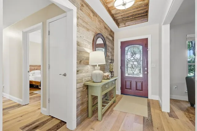 a living room with furniture a window and a flat screen tv