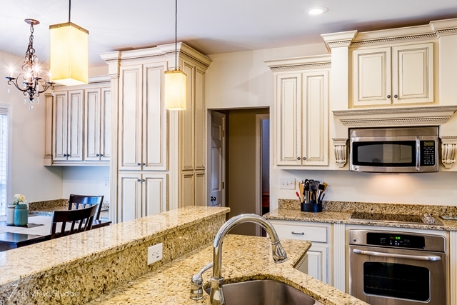 2575 Collier Road Forsyth, GA 31029 - Photo 14 of 25 a kitchen with granite countertop a stove a sink and a microwave