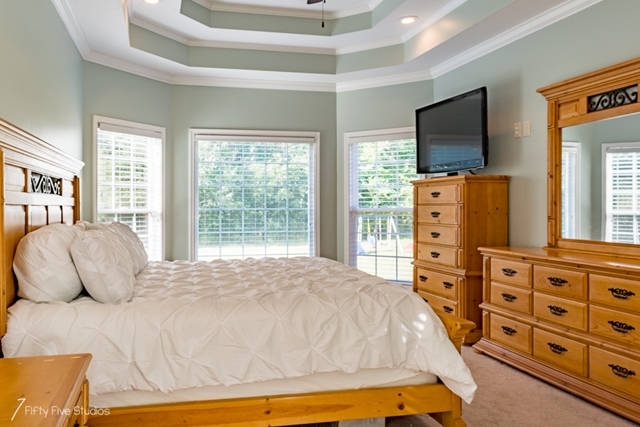 2575 Collier Road Forsyth, GA 31029 - Photo 19 of 25 a bedroom with a bed and wooden floor