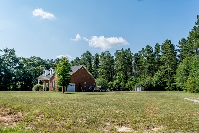 2575 Collier Road Forsyth, GA 31029 - Photo 3 of 25 a front view of house with yard and trees in the background