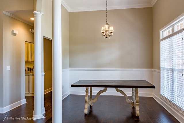 2575 Collier Road Forsyth, GA 31029 - Photo 10 of 25 a view of a dining room with furniture wooden floor and chandelier