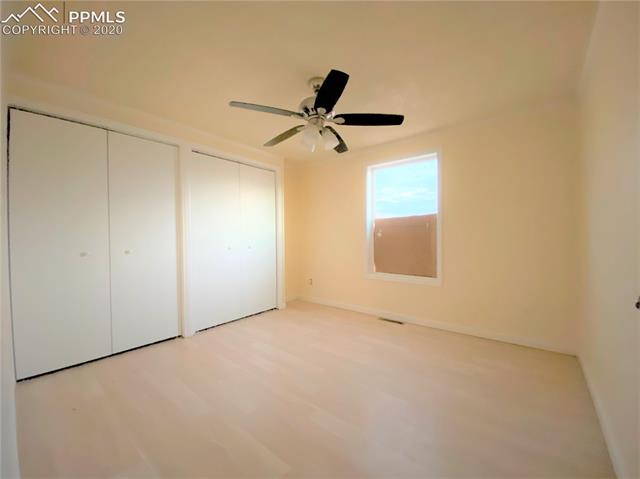 3255 Wiesner Road Calhan, CO 80808 - Photo 24 of 25 Bedroom 2 w/ Ample Closet Space (includes New Interior Paint, New Closet Doors, newer ceiling fan & laminate wood flooring.) Please note: Window is being repaired.
