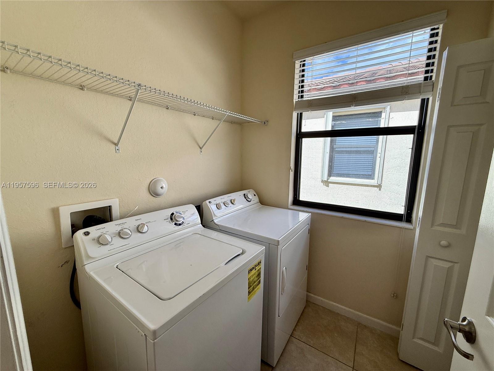 3385 West 86th Terrace, Unit 3385 Hialeah, FL 33018 - Photo 13 of 19 a utility room with dryer and washer