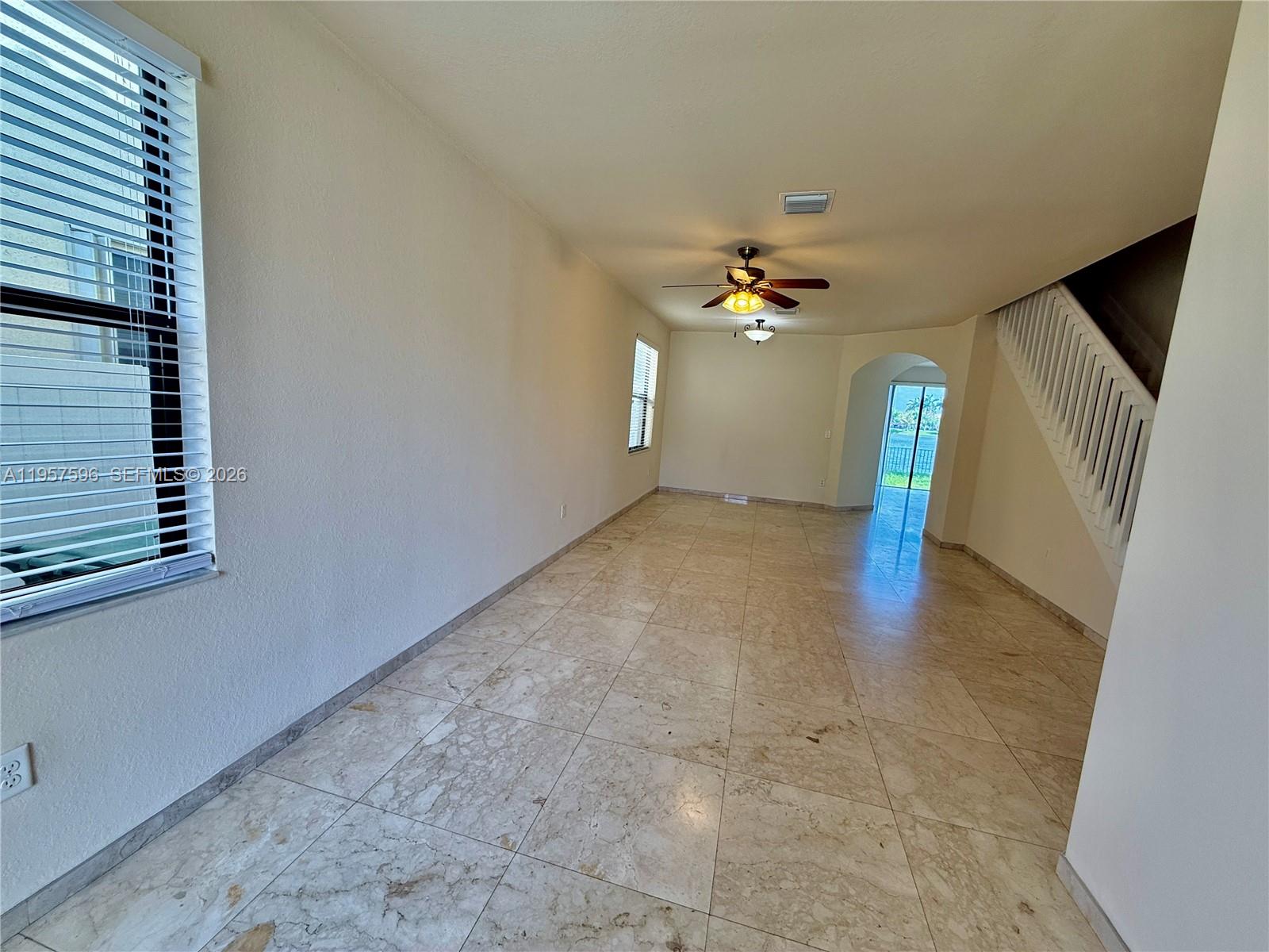 3385 West 86th Terrace, Unit 3385 Hialeah, FL 33018 - Photo 19 of 19 a view of a livingroom with a ceiling fan and window