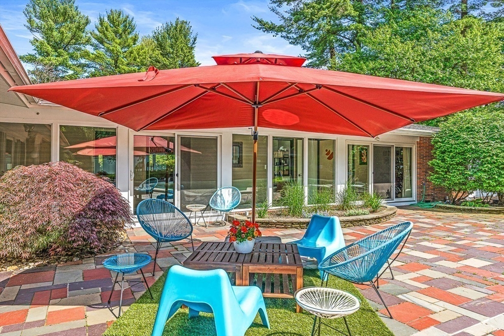 12 Alexandra Road Lynnfield, MA 01940 - Photo 34 of 42 a patio with tables and chairs and a umbrella