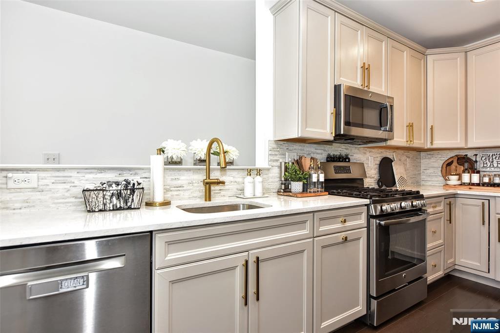 28 Autumn Way, Unit 72 Montvale, NJ 07645 - Photo 15 of 34 a kitchen with stainless steel appliances granite countertop a sink and a stove