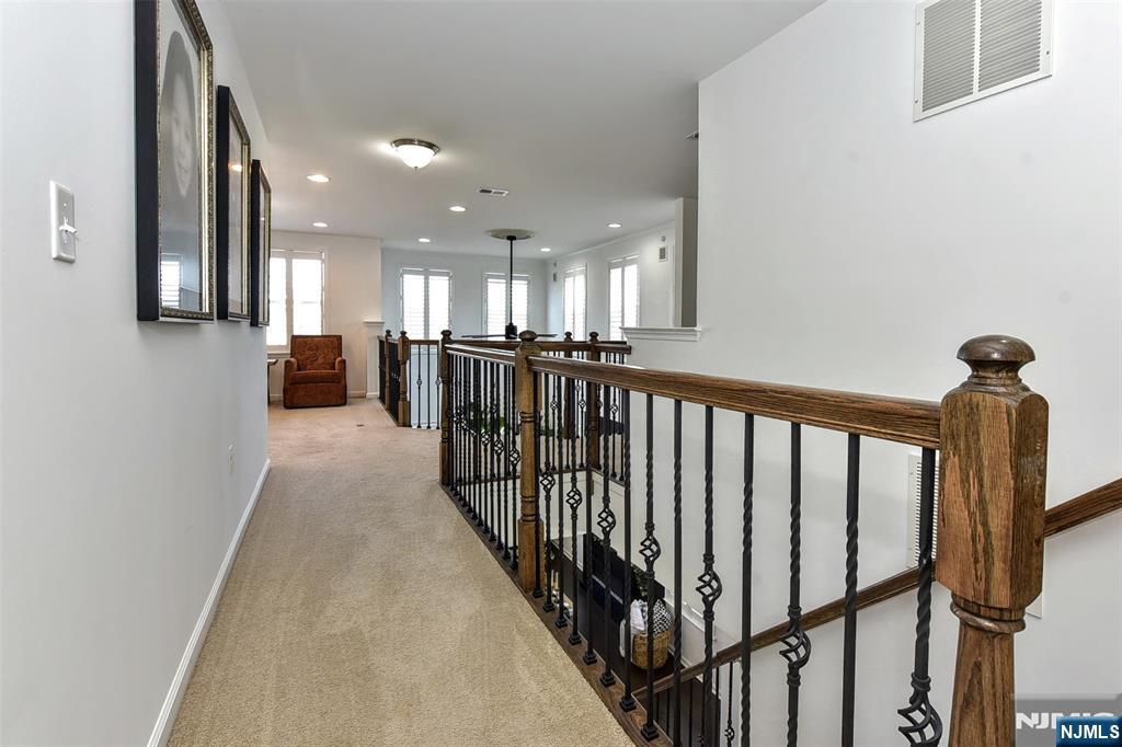 28 Autumn Way, Unit 72 Montvale, NJ 07645 - Photo 19 of 34 a view of a hallway with wooden floor and furniture