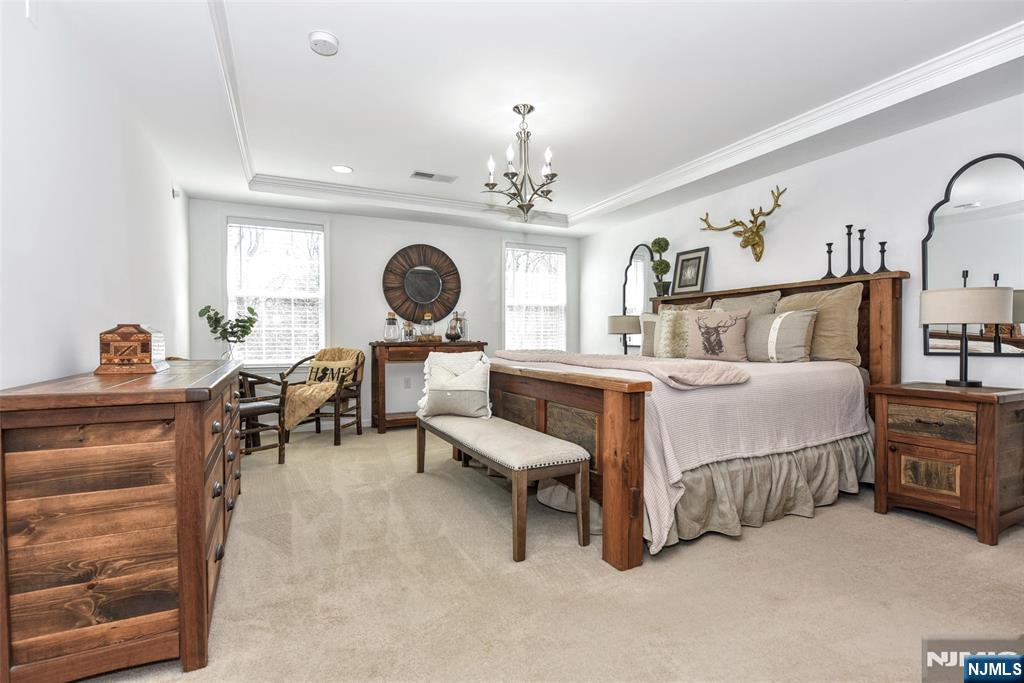 28 Autumn Way, Unit 72 Montvale, NJ 07645 - Photo 24 of 34 a living room with furniture and a chandelier