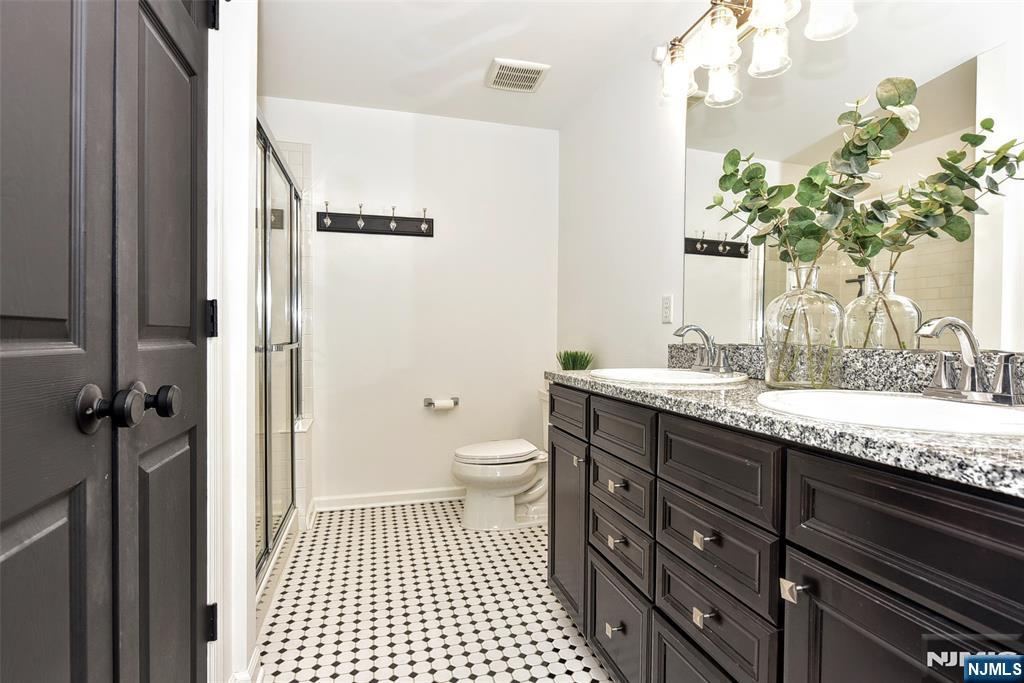 28 Autumn Way, Unit 72 Montvale, NJ 07645 - Photo 26 of 34 a bathroom with a granite countertop sink a toilet and a mirror