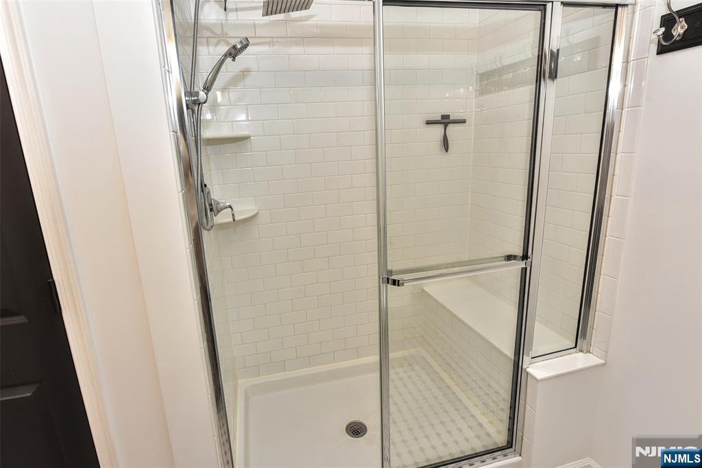 28 Autumn Way, Unit 72 Montvale, NJ 07645 - Photo 27 of 34 a bathroom with a glass shower door