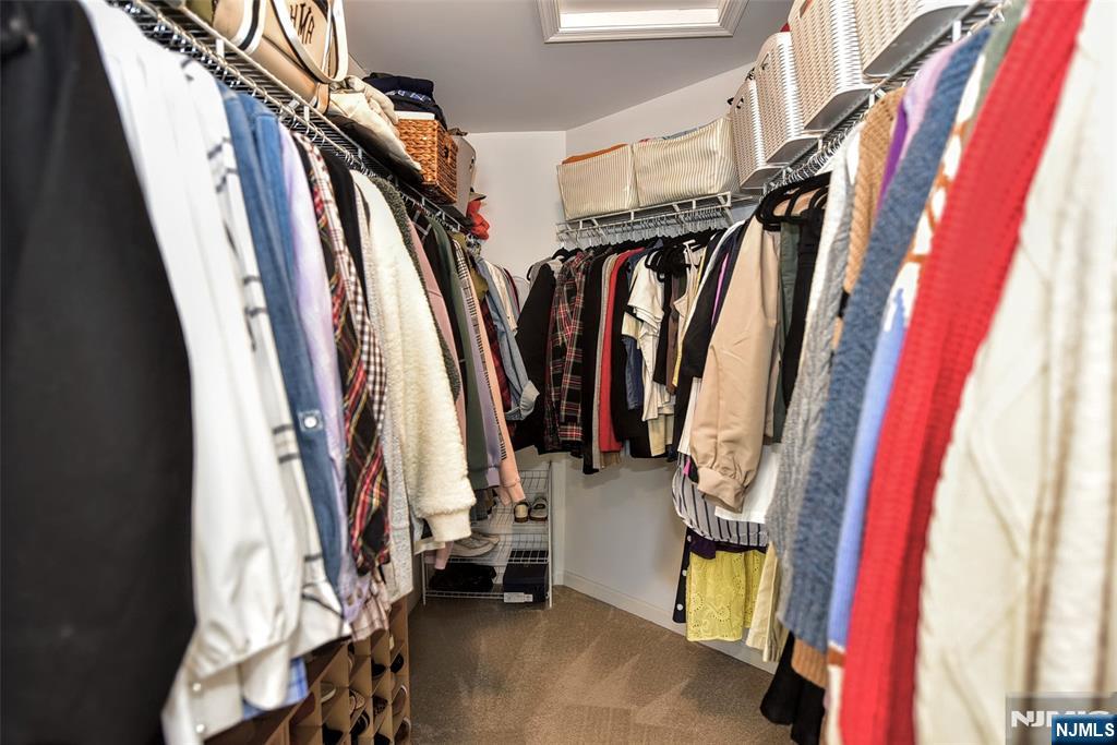 28 Autumn Way, Unit 72 Montvale, NJ 07645 - Photo 28 of 34 a view of walk in closet with clothes and shoes