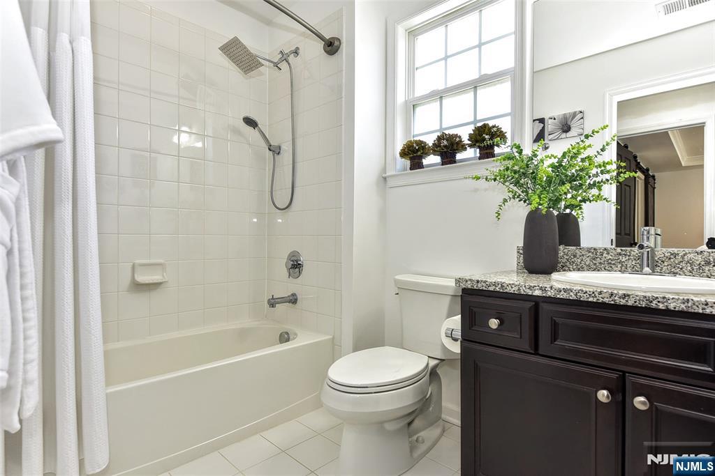 28 Autumn Way, Unit 72 Montvale, NJ 07645 - Photo 30 of 34 a bathroom with a granite countertop sink a toilet and shower