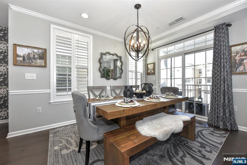 28 Autumn Way, Unit 72 Montvale, NJ 07645 - Photo 7 of 34 a view of a dining room with furniture wooden floor and chandelier