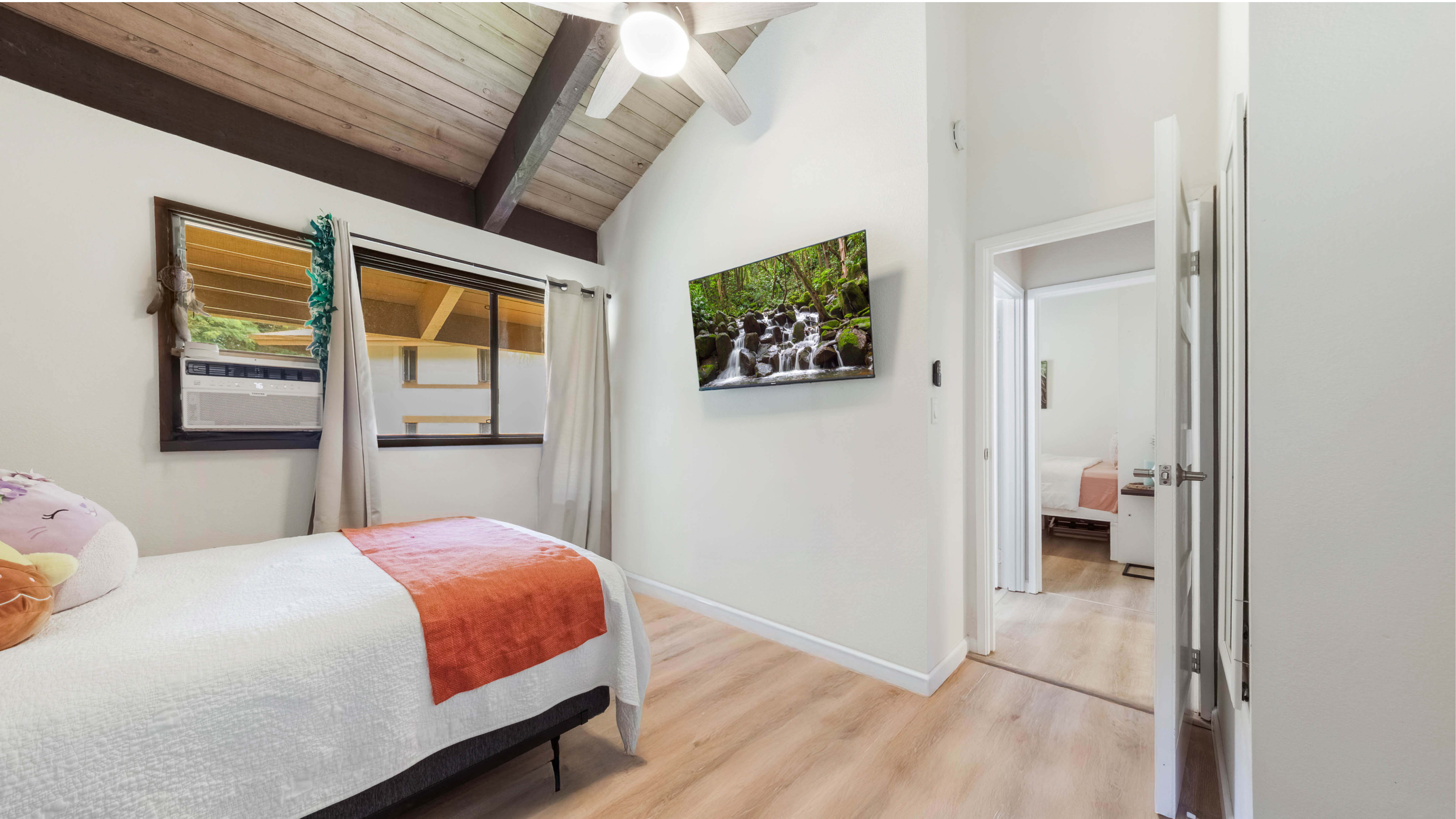 4701 Kawaihau Road, Unit L201 Kapaa, HI 96746 - Photo 15 of 29 a bedroom with a bed and a painting on the wall