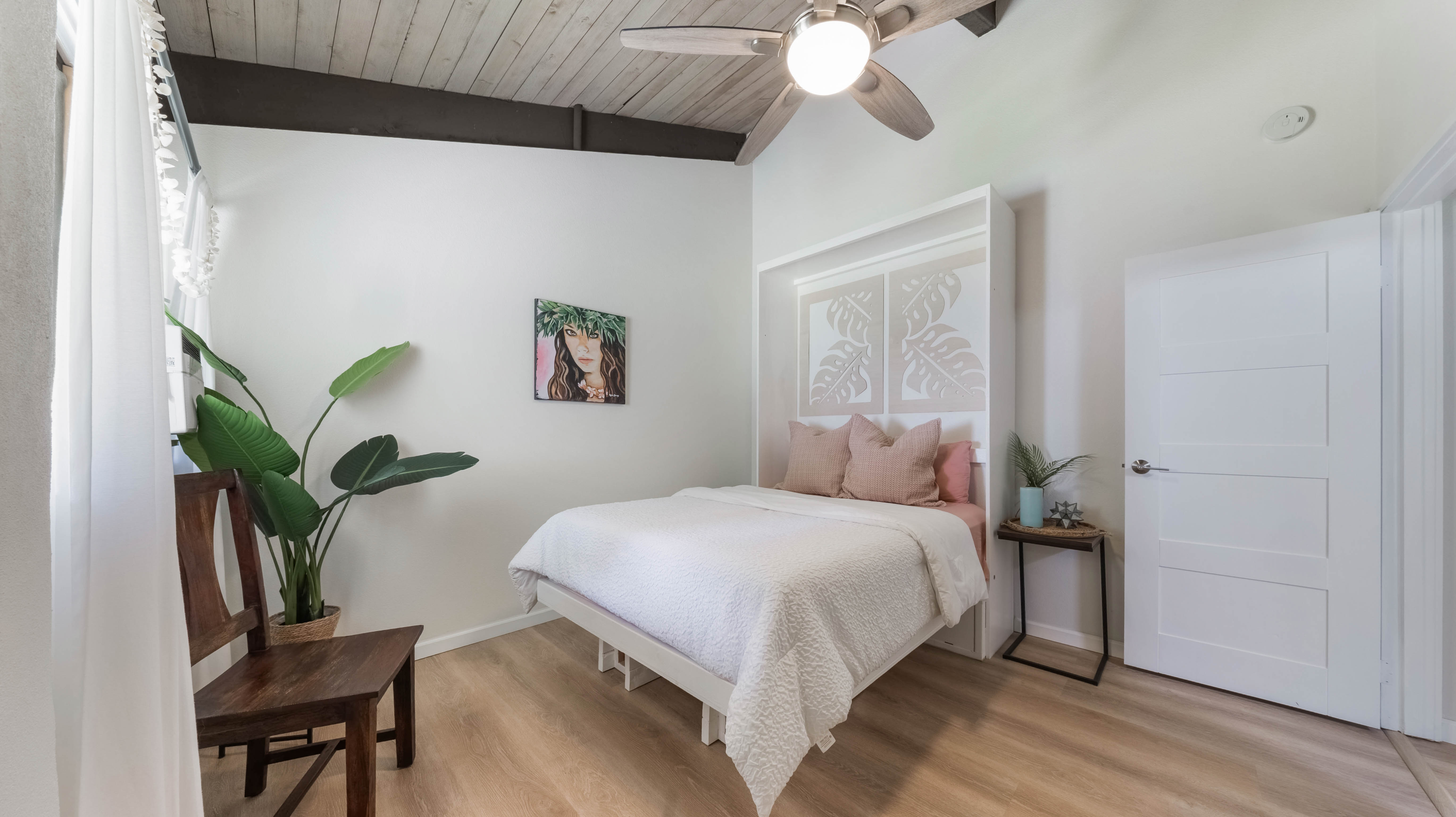 4701 Kawaihau Road, Unit L201 Kapaa, HI 96746 - Photo 17 of 29 a bedroom with a bed and a potted plant