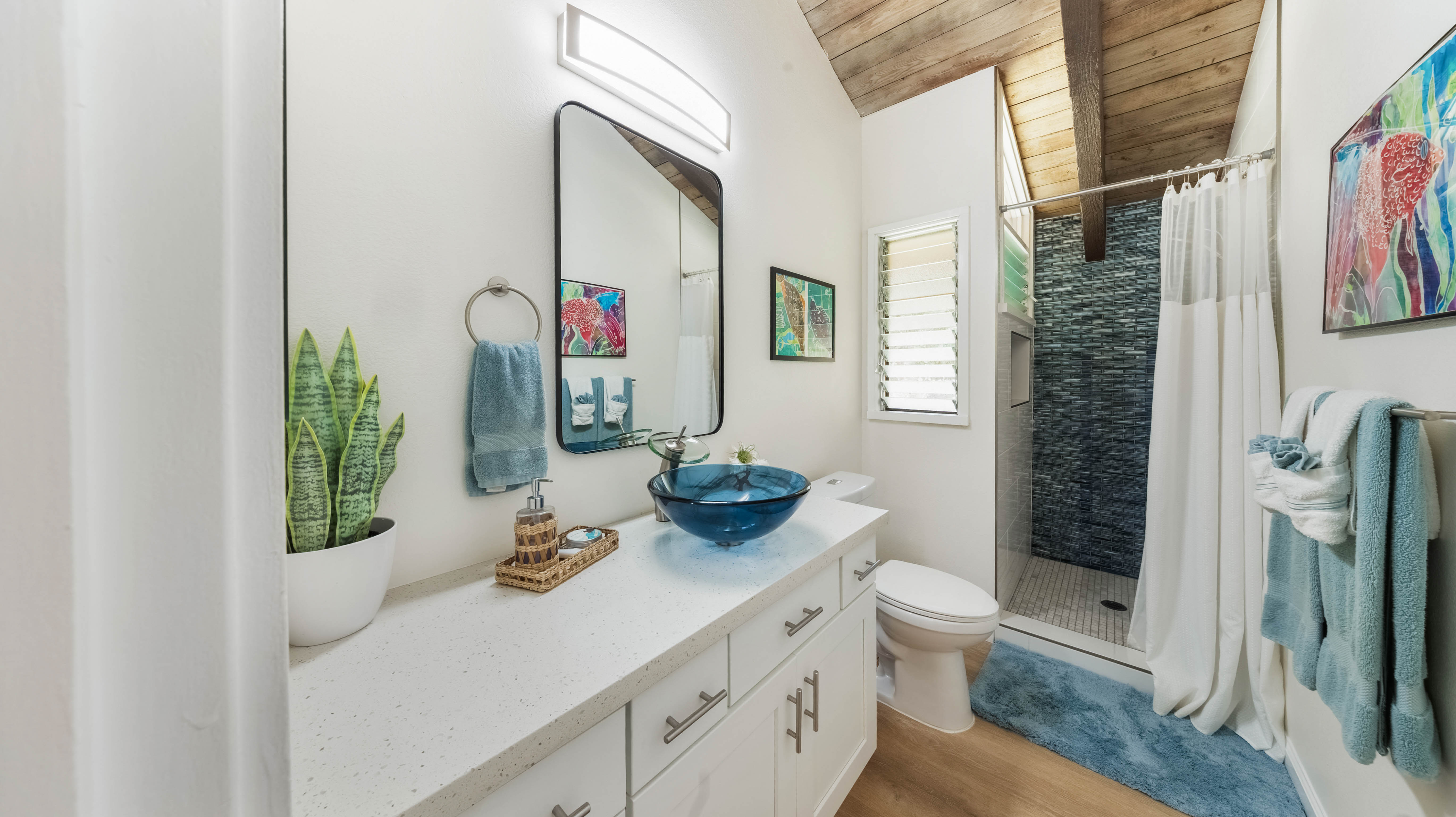 4701 Kawaihau Road, Unit L201 Kapaa, HI 96746 - Photo 18 of 29 a bathroom with a sink a toilet and shower curtain