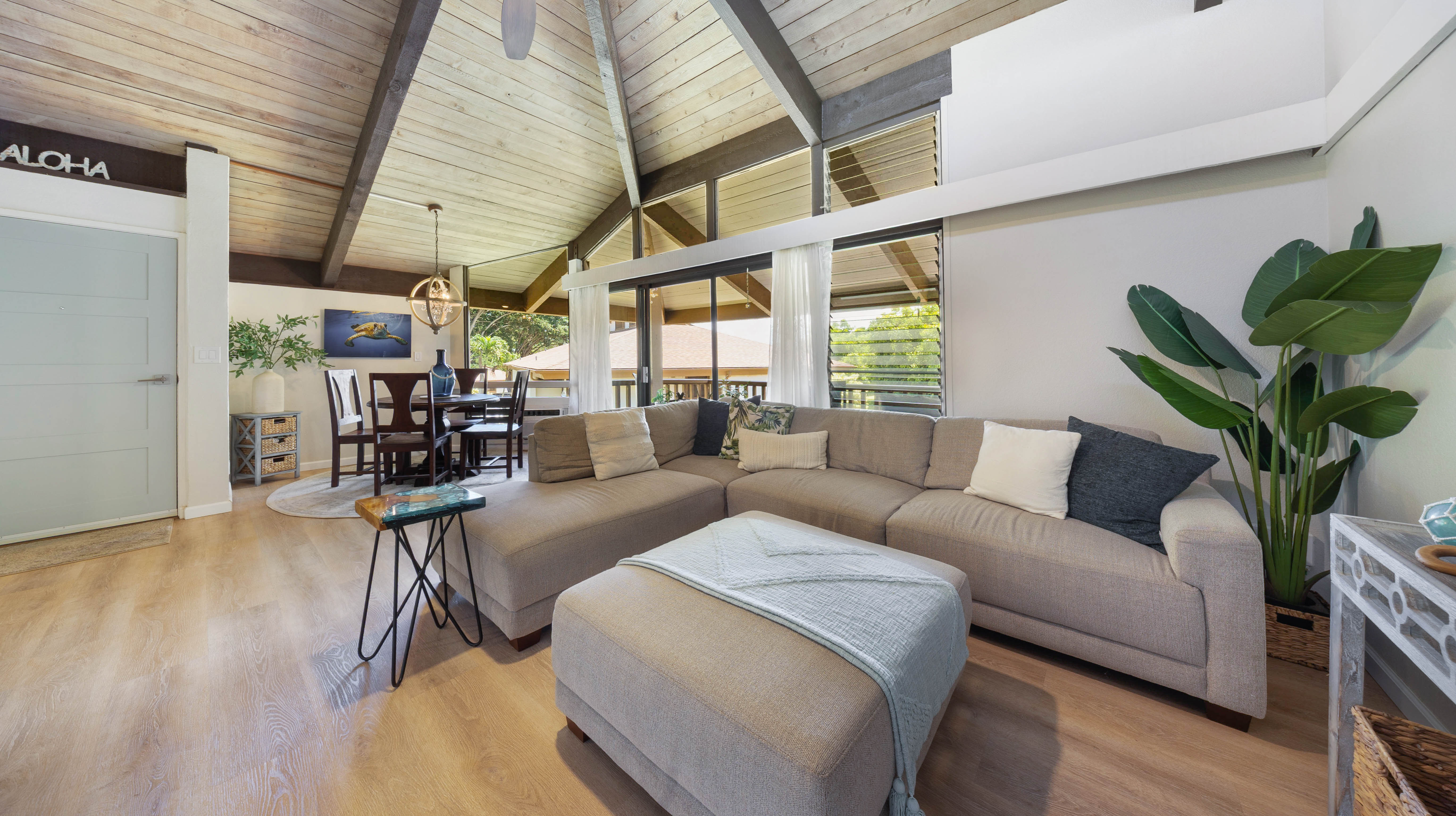 4701 Kawaihau Road, Unit L201 Kapaa, HI 96746 - Photo 8 of 29 a living room with furniture a wooden floor and a potted plant