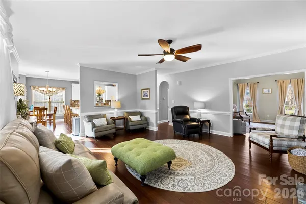 a living room with furniture and a chandelier