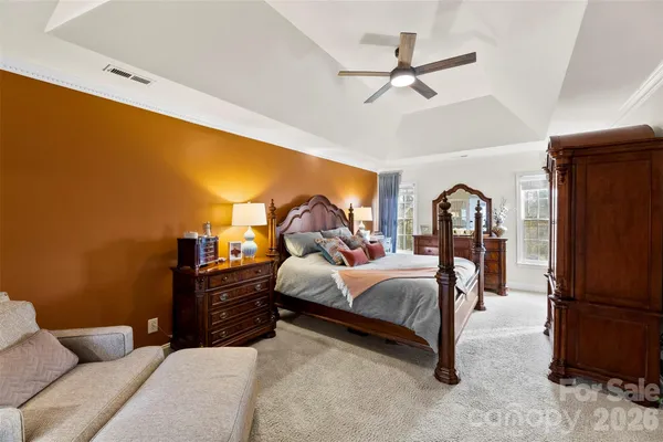 a bed room with a bed and a ceiling fan