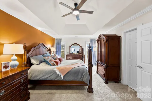 a bedroom with a bed dresser and a window