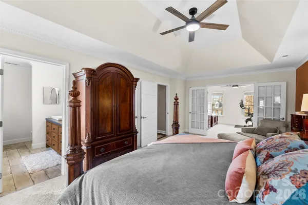 a bedroom with a bed and a chandelier
