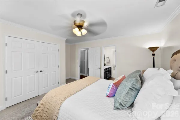 a bedroom with a bed and hallway
