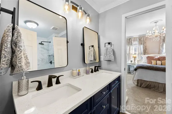 a en suite bathroom with a sink double vanity and a mirror